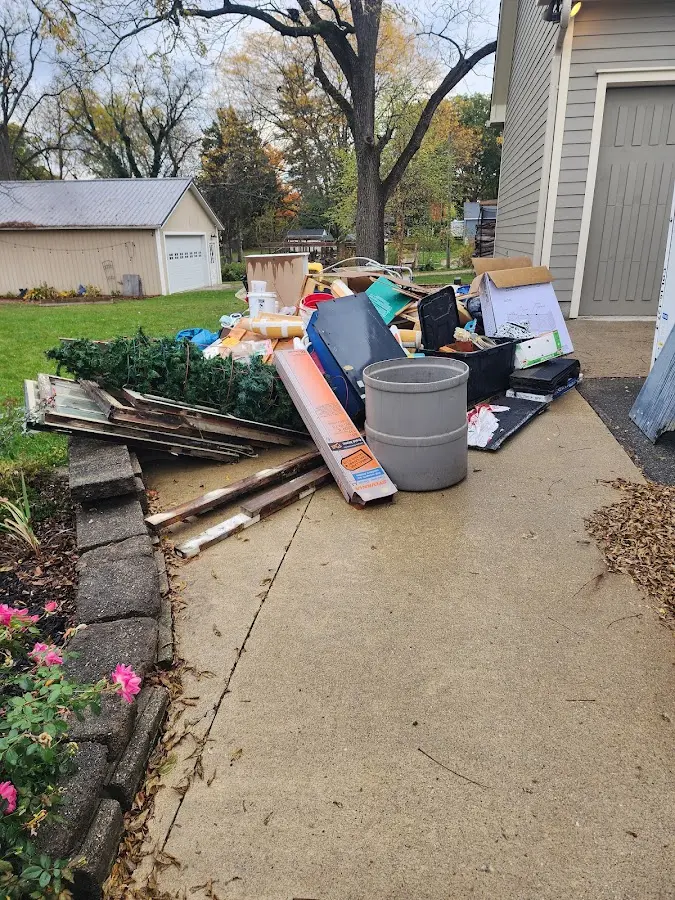 Dumpster being loaded with debris for Estate Cleanout Dumpster Rental in Hampden
